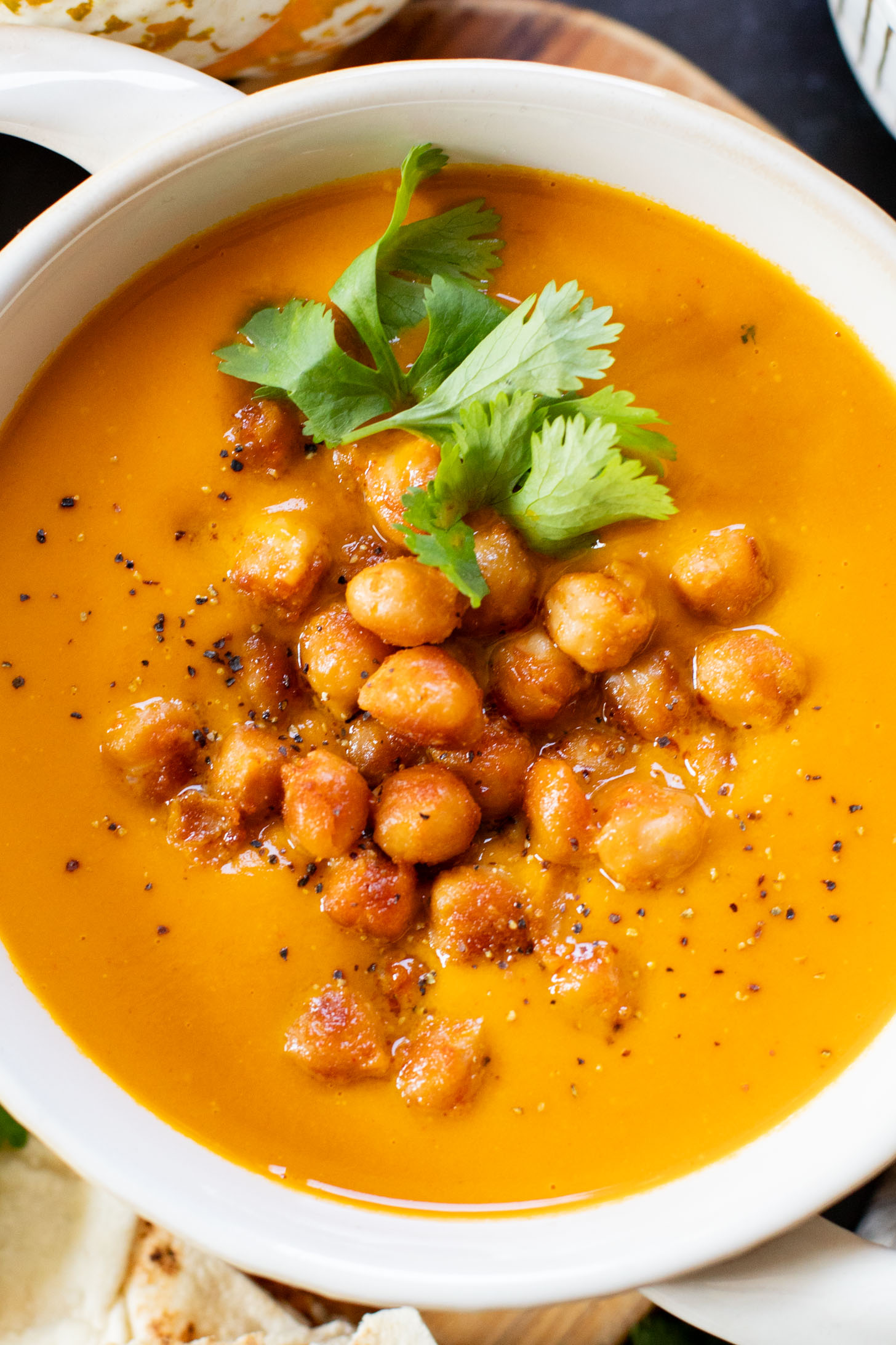 Creamy and comforting, this Thai Curry Pumpkin Soup is a dairy-free fall soup that everyone will love. Topped with crispy chickpeas | ThisSavoryVegan.com