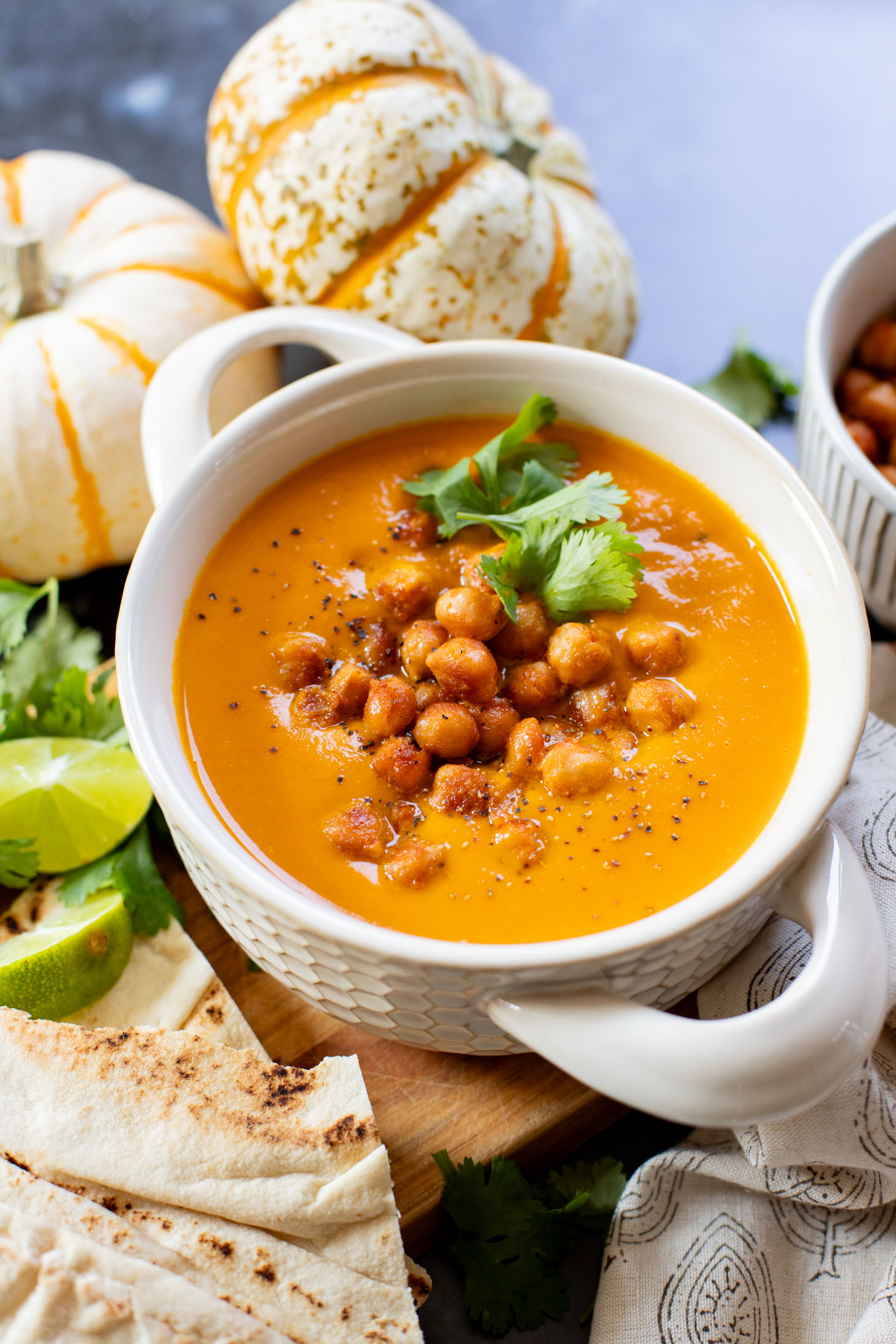 Creamy and comforting, this Thai Curry Pumpkin Soup is a dairy-free fall soup that everyone will love. Topped with crispy chickpeas | ThisSavoryVegan.com