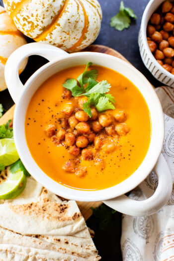 Creamy and comforting, this Thai Curry Pumpkin Soup is a dairy-free fall soup that everyone will love. Topped with crispy chickpeas | ThisSavoryVegan.com