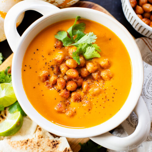 Creamy and comforting, this Thai Curry Pumpkin Soup is a dairy-free fall soup that everyone will love. Topped with crispy chickpeas | ThisSavoryVegan.com