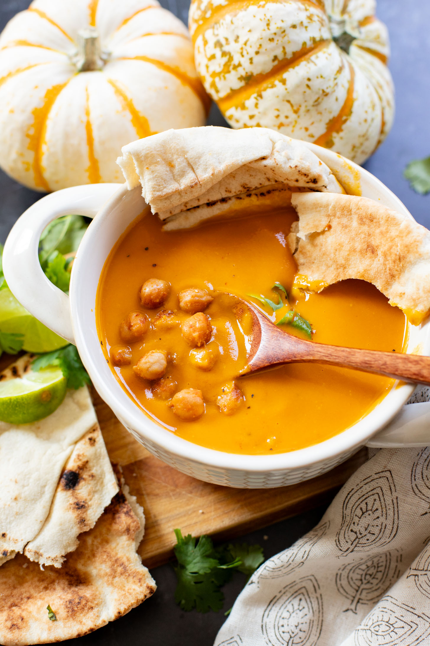 Creamy and comforting, this Thai Curry Pumpkin Soup is a dairy-free fall soup that everyone will love. Topped with crispy chickpeas | ThisSavoryVegan.com