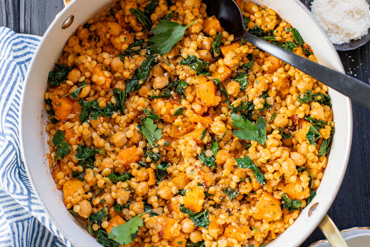 This Fall Harvest Couscous Skillet is filled with roasted squash, chickpeas, kale and pearl couscous. Serve it hot or chilled | ThisSavoryVegan.com