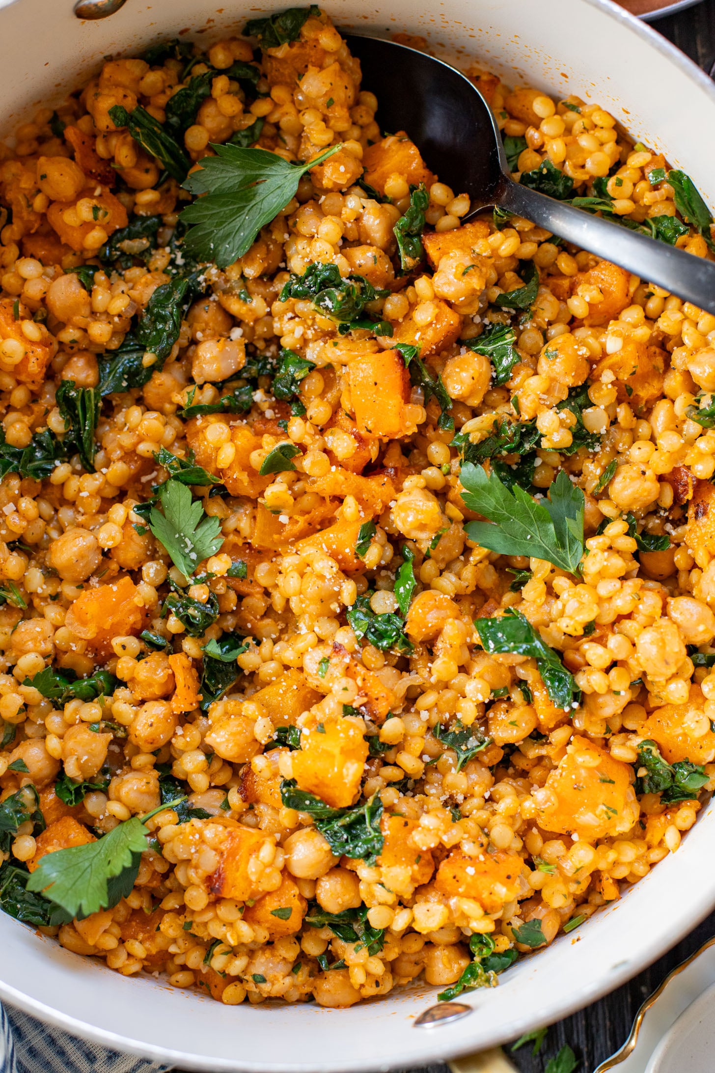 This Fall Harvest Couscous Skillet is filled with roasted squash, chickpeas, kale and pearl couscous. Serve it hot or chilled | ThisSavoryVegan.com