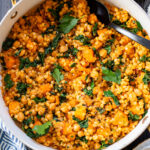 This Fall Harvest Couscous Skillet is filled with roasted squash, chickpeas, kale and pearl couscous. Serve it hot or chilled | ThisSavoryVegan.com