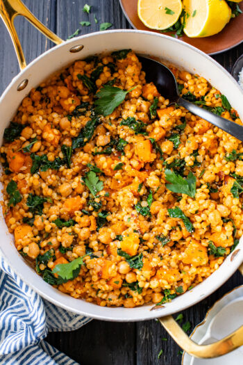 This Fall Harvest Couscous Skillet is filled with roasted squash, chickpeas, kale and pearl couscous. Serve it hot or chilled | ThisSavoryVegan.com