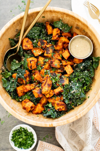 This Harissa Sweet Potato Kale Salad is layered with kale, lentils, vegan honey mustard dressing and crispy roasted sweet potatoes | ThisSavoryVegan.com