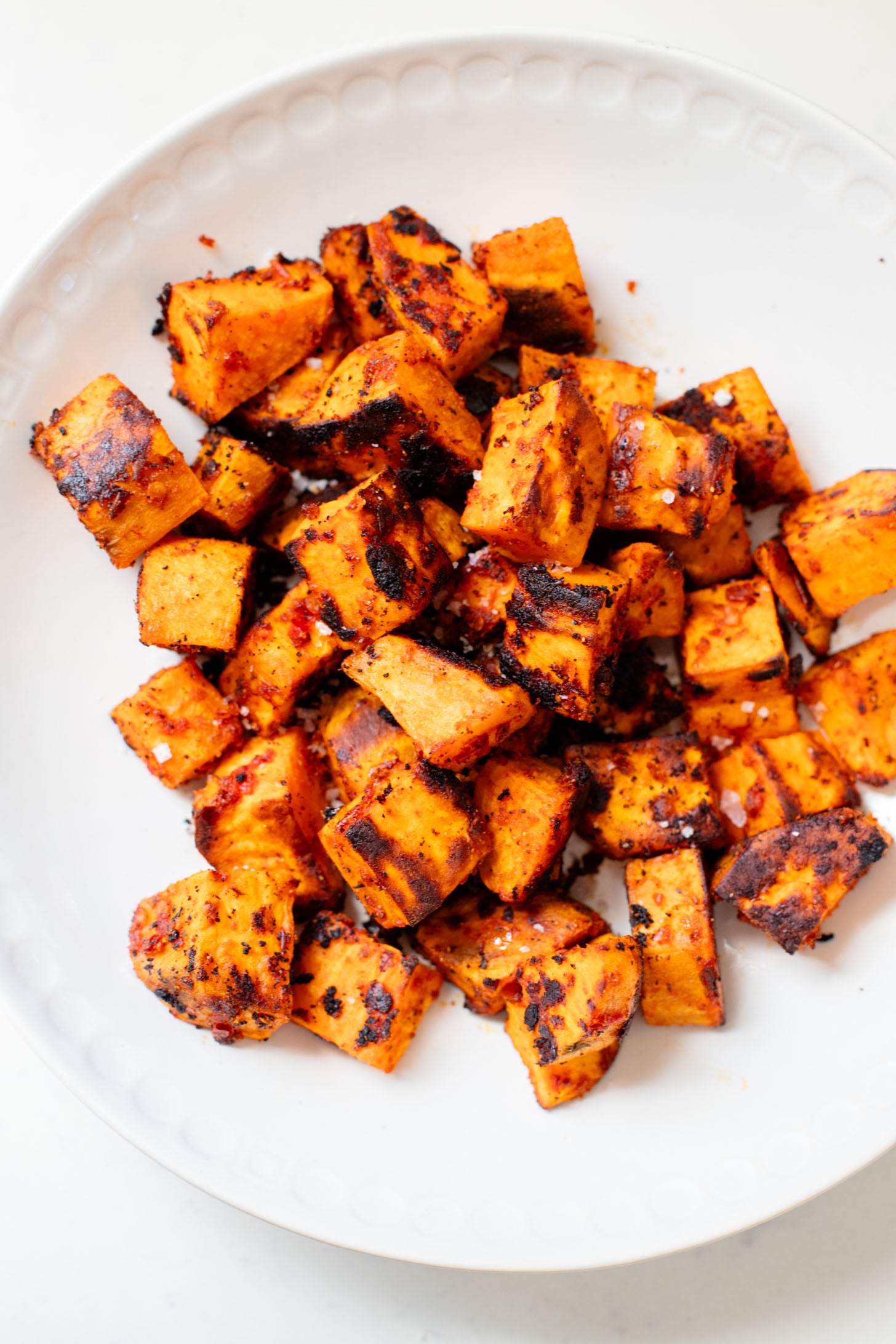 This Harissa Sweet Potato Kale Salad is layered with kale, lentils, vegan honey mustard dressing and crispy roasted sweet potatoes | ThisSavoryVegan.com