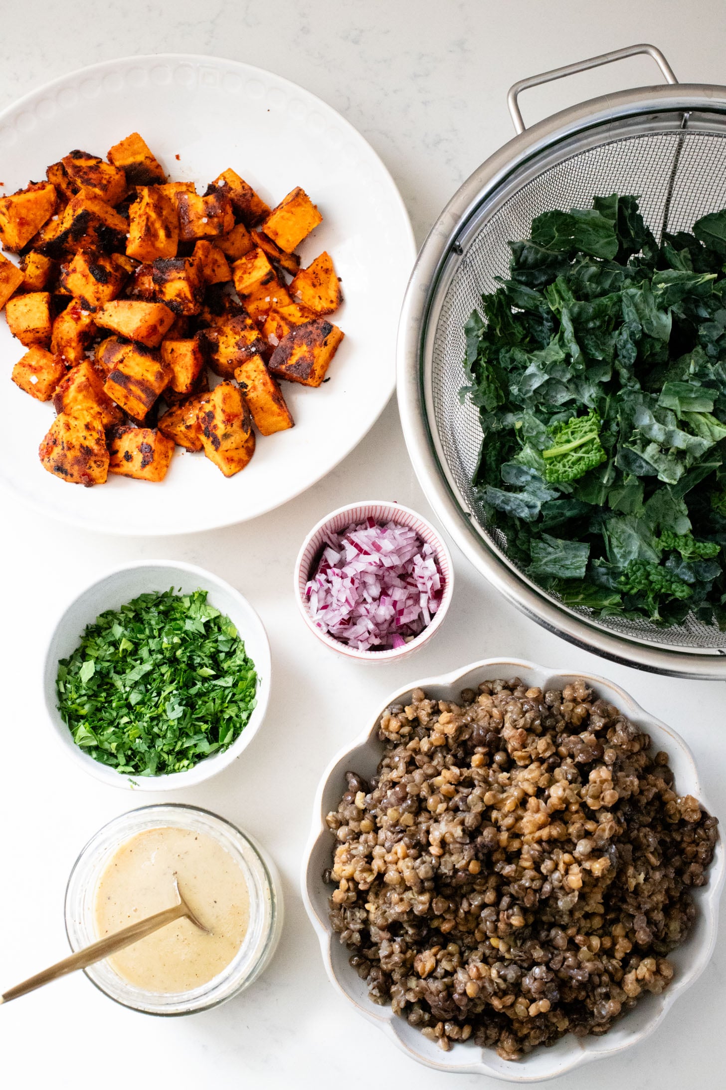 This Harissa Sweet Potato Kale Salad is layered with kale, lentils, vegan honey mustard dressing and crispy roasted sweet potatoes | ThisSavoryVegan.com