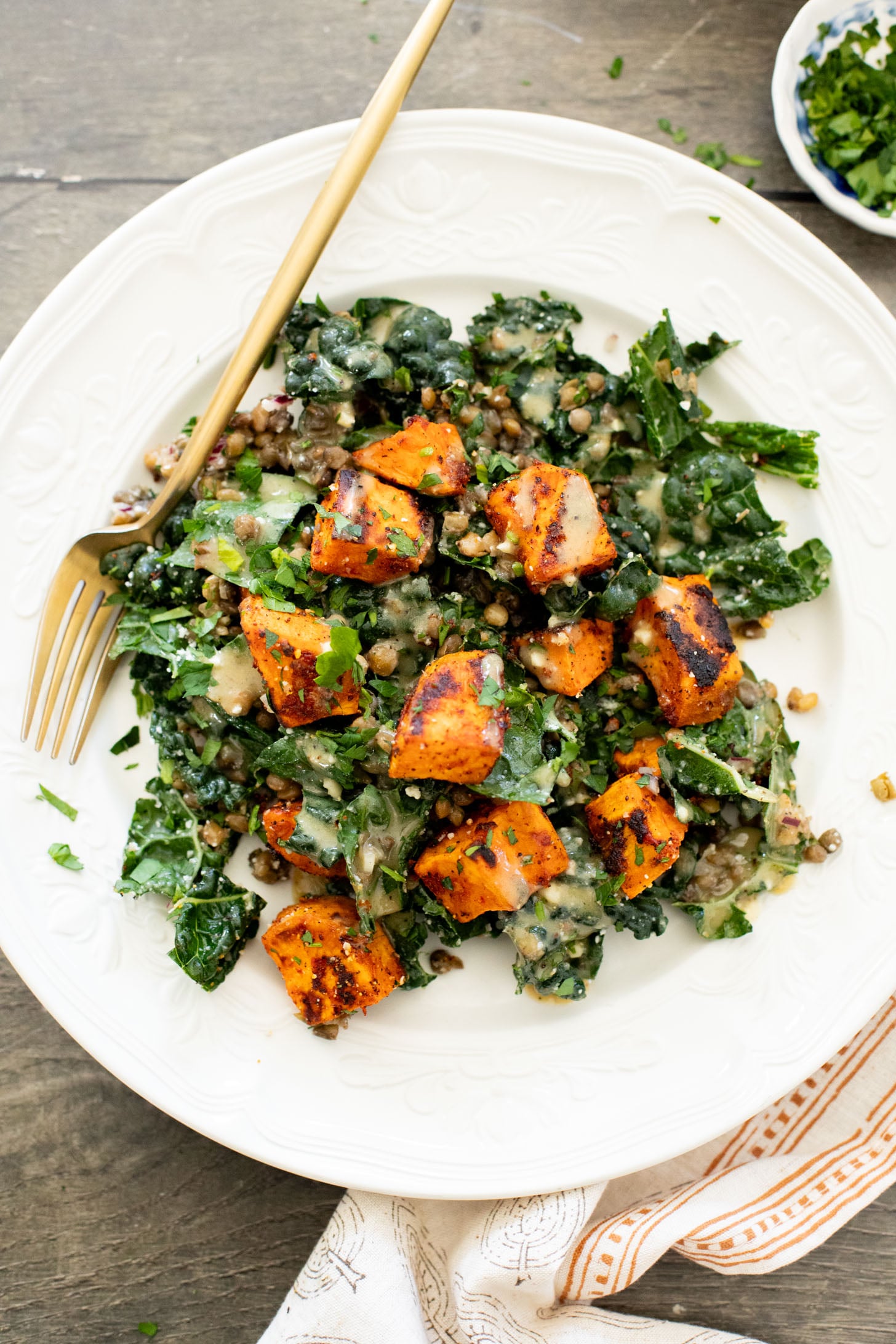 This Harissa Sweet Potato Kale Salad is layered with kale, lentils, vegan honey mustard dressing and crispy roasted sweet potatoes | ThisSavoryVegan.com