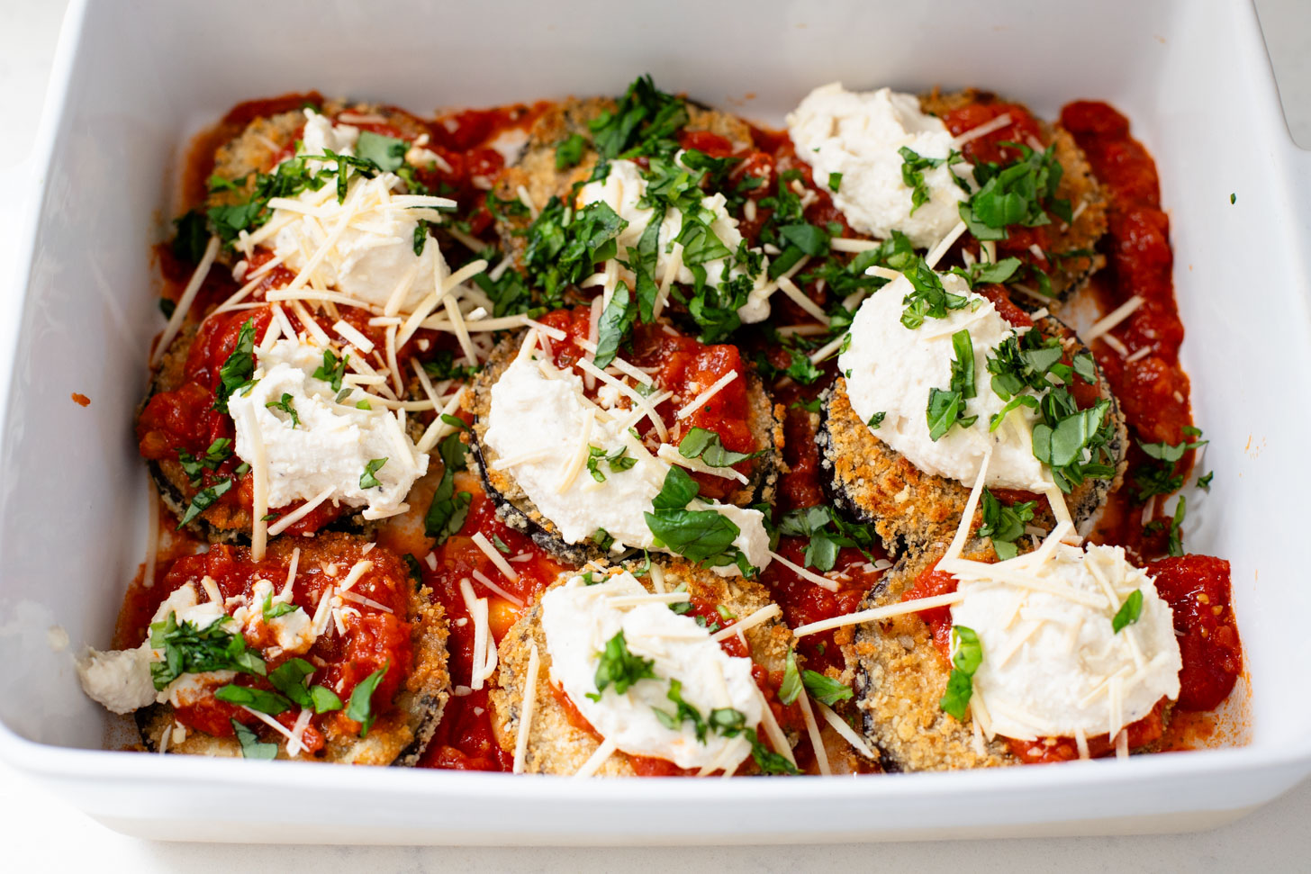 This Baked Eggplant Parmesan is dairy-free and has some sneaky protein in there. Serve with a salad for a low carb dinner or with a bowl of pasta | ThisSavoryVegan.com
