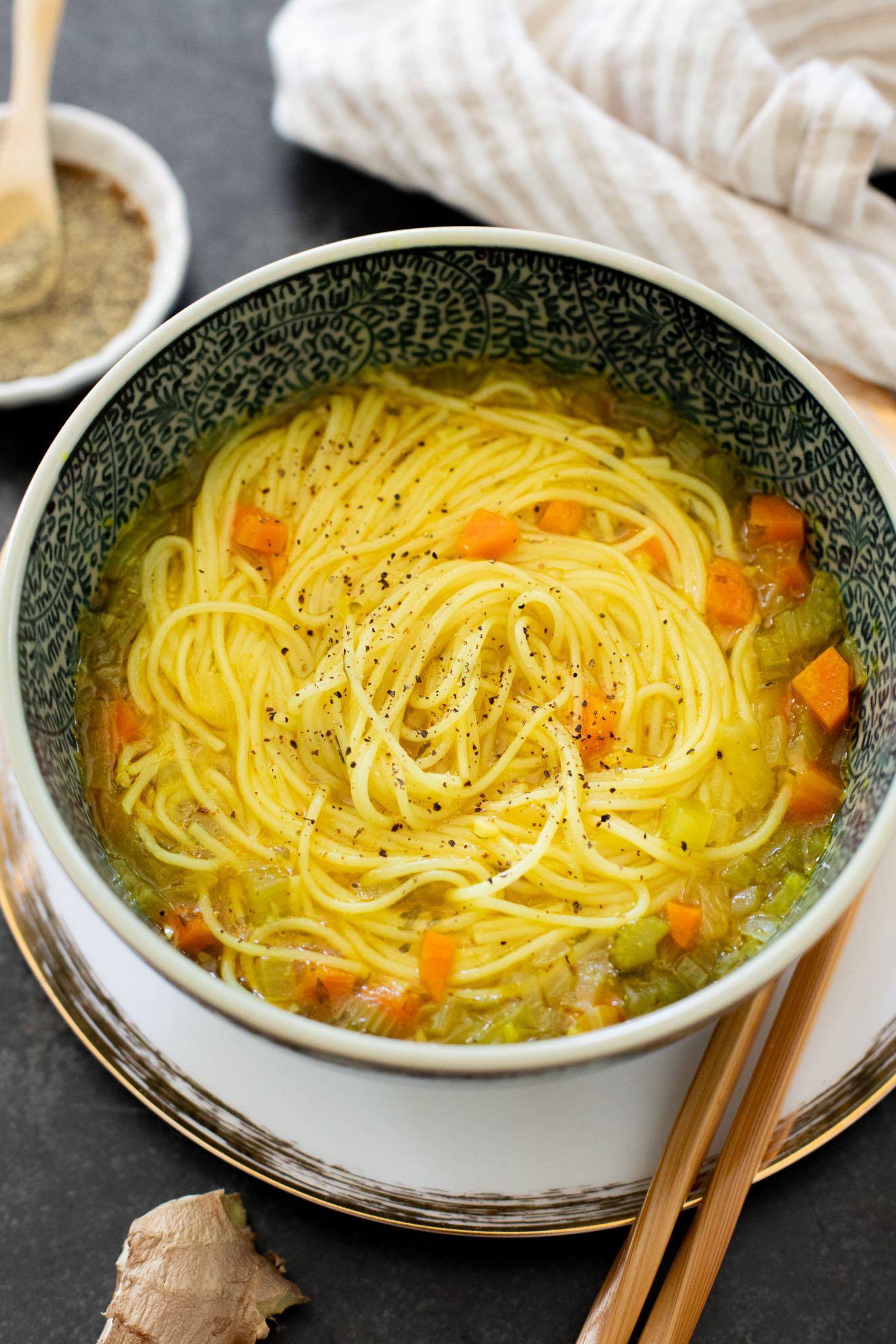 Perfect for a cold day, this Brothy Ginger Noodle Soup is simple and flavorful. A veggie broth base, with tender veggies and rice noodles | ThisSavoryVegan.com