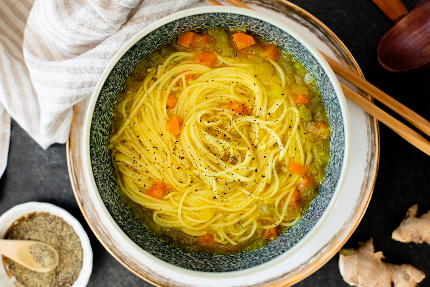Perfect for a cold day, this Brothy Ginger Noodle Soup is simple and flavorful. A veggie broth base, with tender veggies and rice noodles | ThisSavoryVegan.com