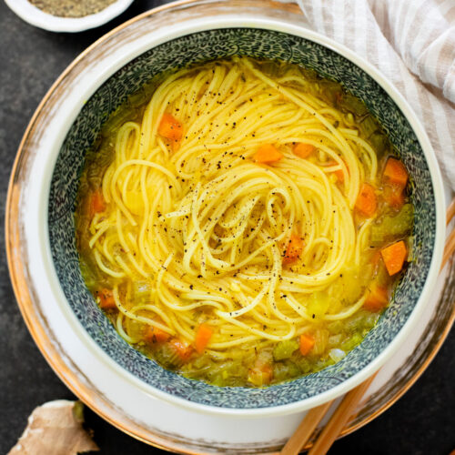 Perfect for a cold day, this Brothy Ginger Noodle Soup is simple and flavorful. A veggie broth base, with tender veggies and rice noodles | ThisSavoryVegan.com