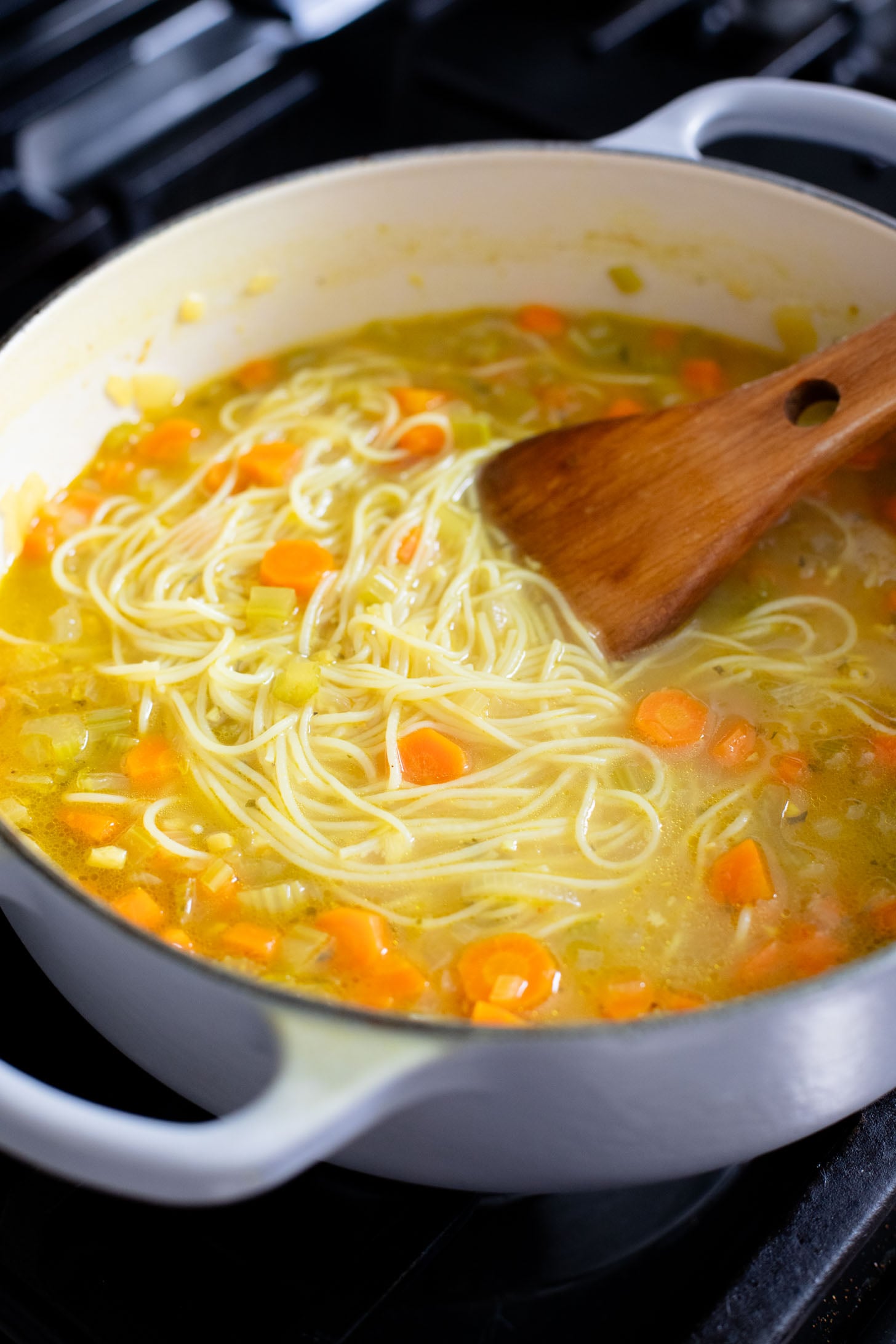 Perfect for a cold day, this Brothy Ginger Noodle Soup is simple and flavorful. A veggie broth base, with tender veggies and rice noodles | ThisSavoryVegan.com