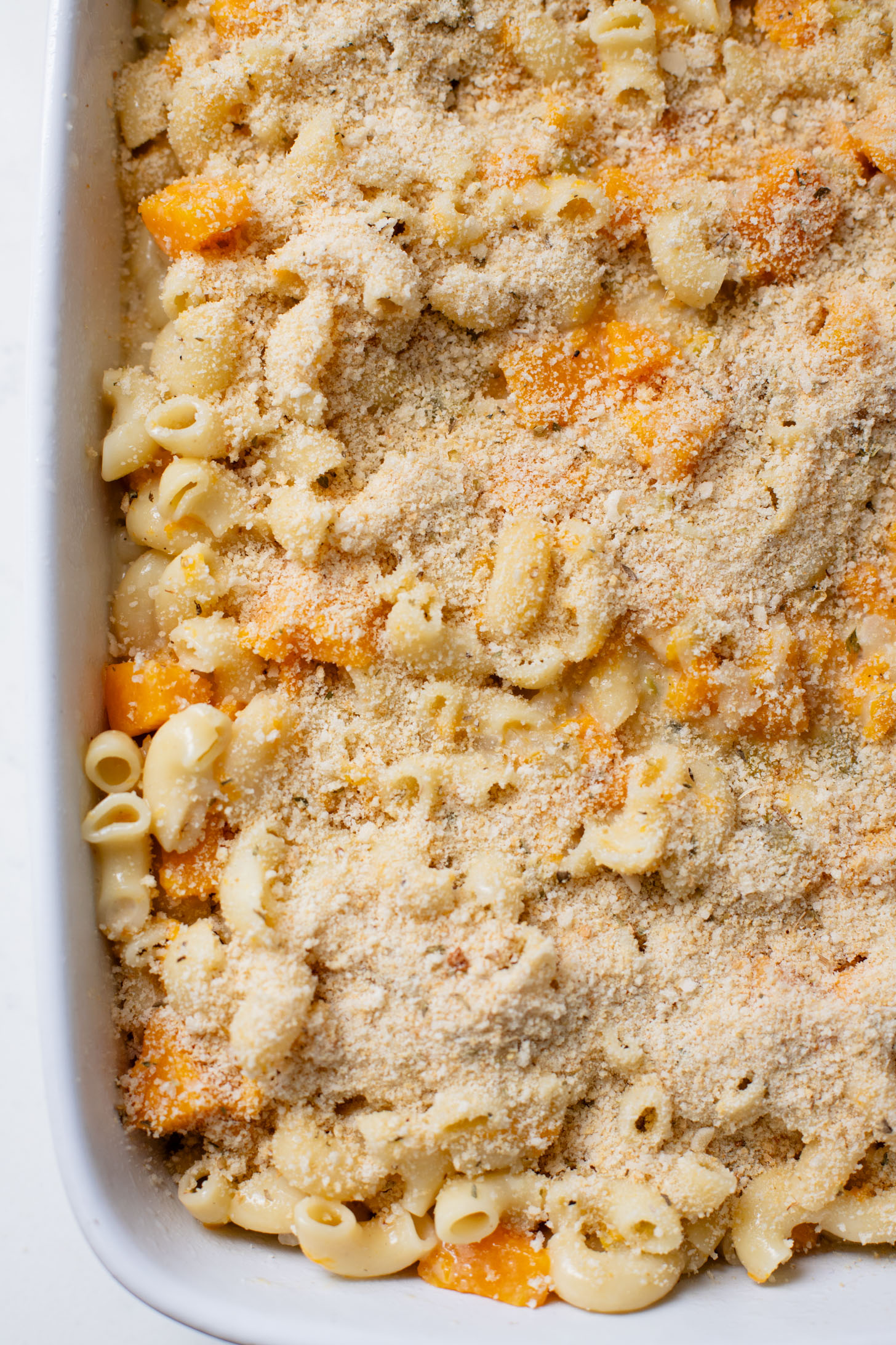 This Cheesy Butternut Squash Pasta Bake is the perfect vegan holiday casserole! Made with a dairy-free cheese sauce & tender squash pieces | ThisSavoryVegan.com