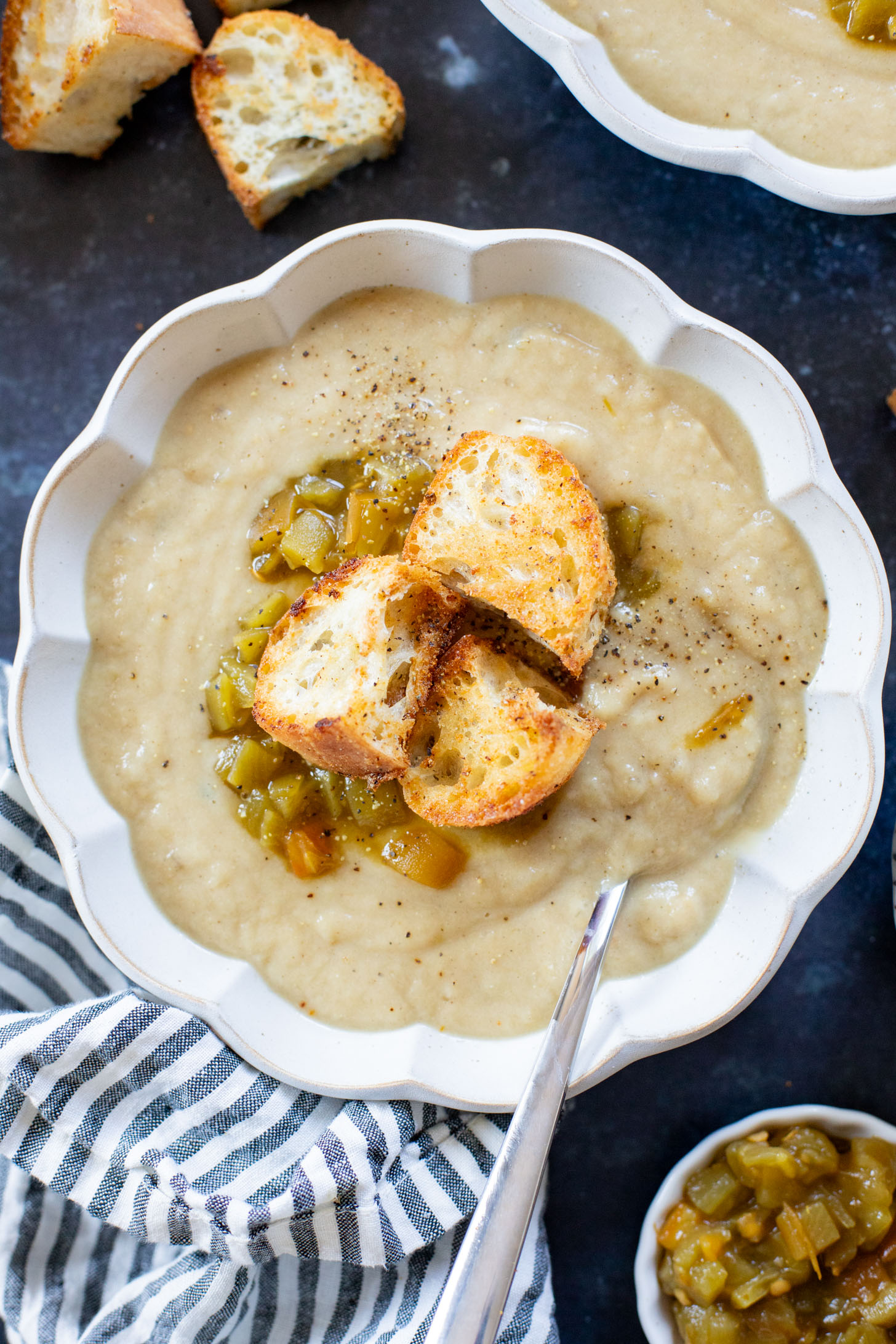 This Salsa Verde Cauliflower Soup is creamy & delicious. The salsa verde adds an unexpected and tasty flavor that takes this dairy-free soup to the next level | ThisSavoryVegan.com