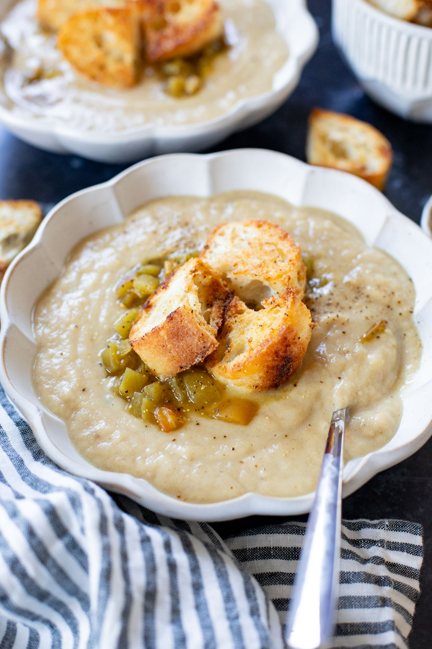 This Salsa Verde Cauliflower Soup is creamy & delicious. The salsa verde adds an unexpected and tasty flavor that takes this dairy-free soup to the next level | ThisSavoryVegan.com