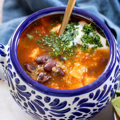 Healthy & delicious, this Sweet Potato Black Bean Soup is loaded with veggies, black beans and quinoa. Made in one pot in under an hour | ThisSavoryVegan.com