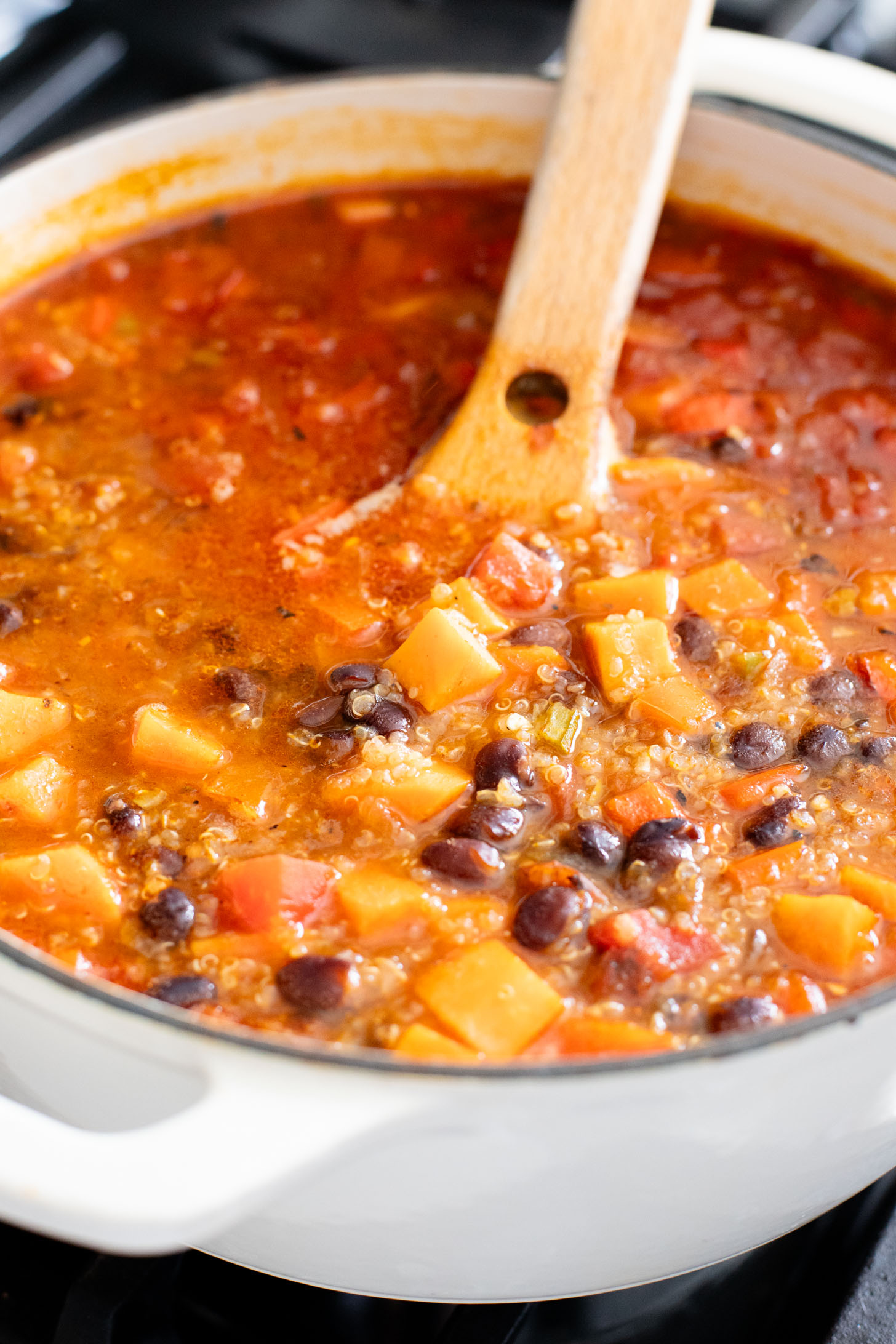 Healthy & delicious, this Sweet Potato Black Bean Soup is loaded with veggies, black beans and quinoa. Made in one pot in under an hour | ThisSavoryVegan.com