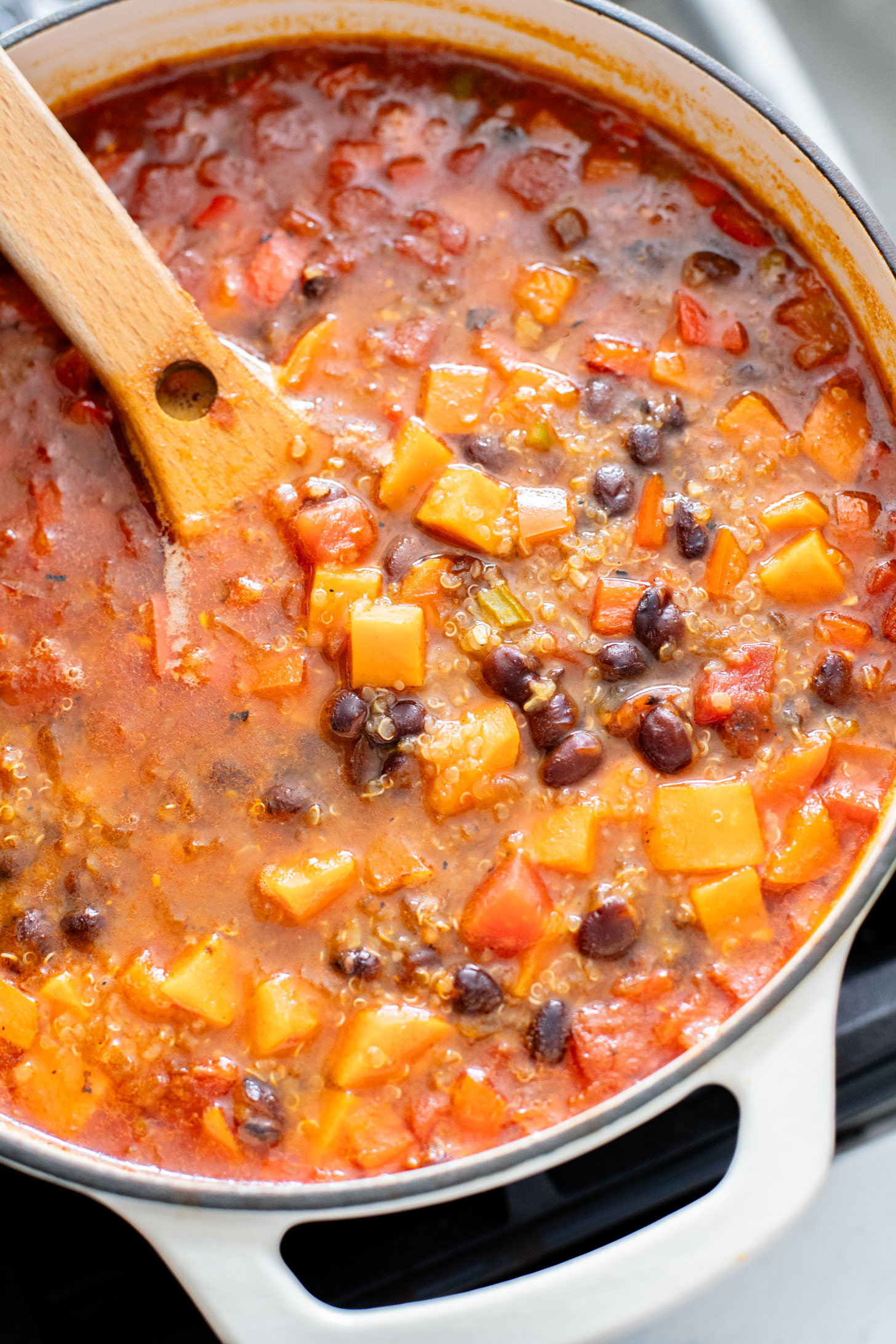 Healthy & delicious, this Sweet Potato Black Bean Soup is loaded with veggies, black beans and quinoa. Made in one pot in under an hour | ThisSavoryVegan.com