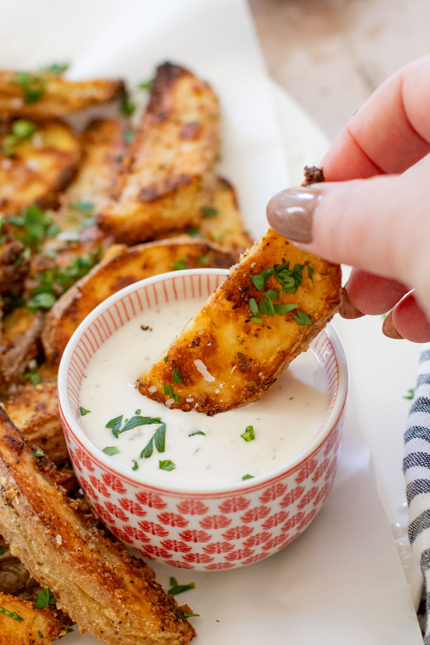 These Vegan Parmesan Crusted Potato Wedges are the most satisfying way to eat potatoes. Perfectly crispy and garlicky | ThisSavoryVegan.com