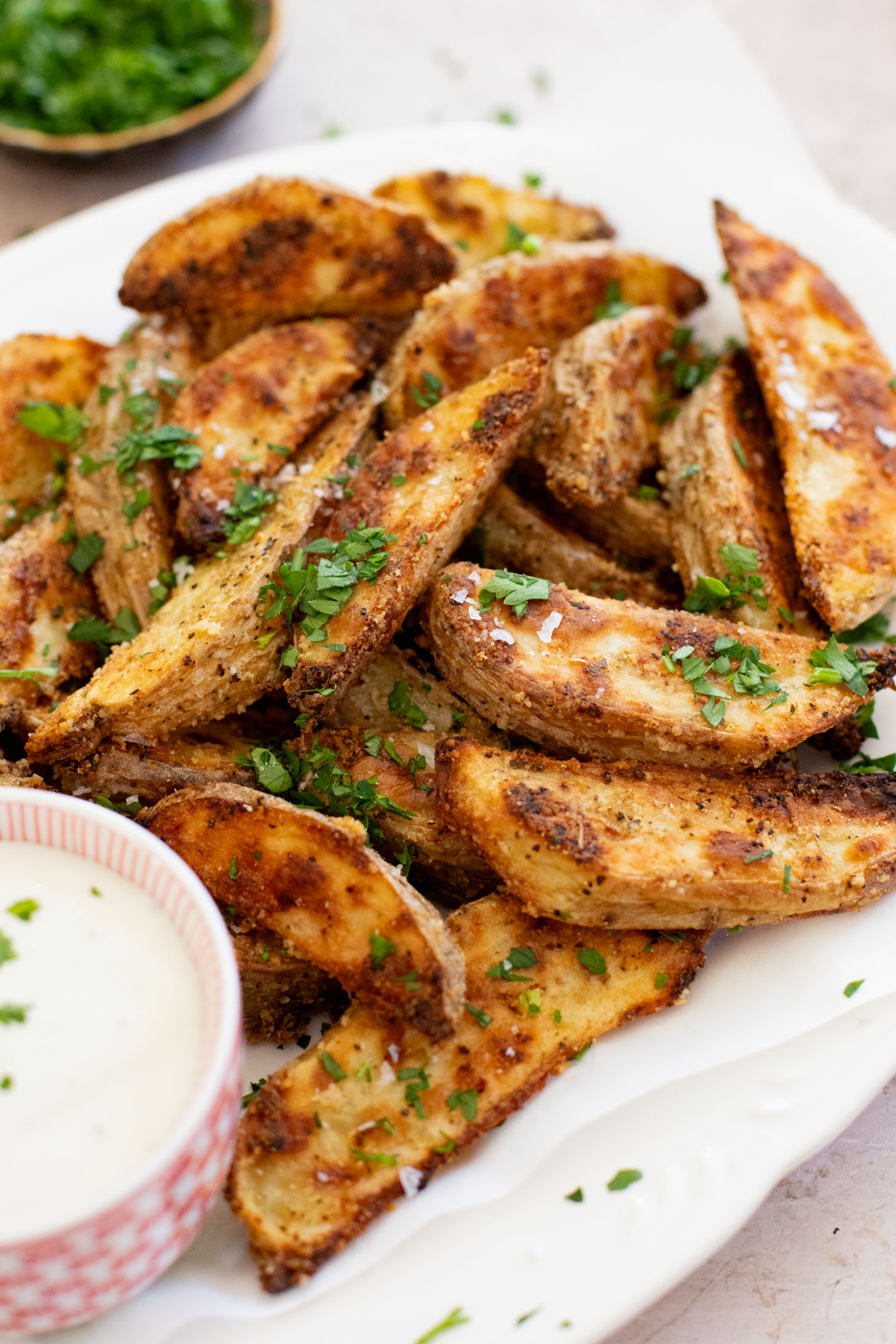 These Vegan Parmesan Crusted Potato Wedges are the most satisfying way to eat potatoes. Perfectly crispy and garlicky | ThisSavoryVegan.com