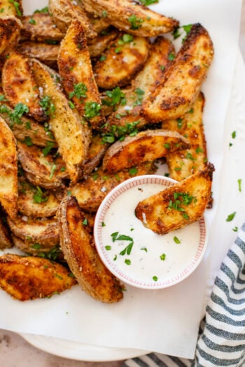 These Vegan Parmesan Crusted Potato Wedges are the most satisfying way to eat potatoes. Perfectly crispy and garlicky | ThisSavoryVegan.com