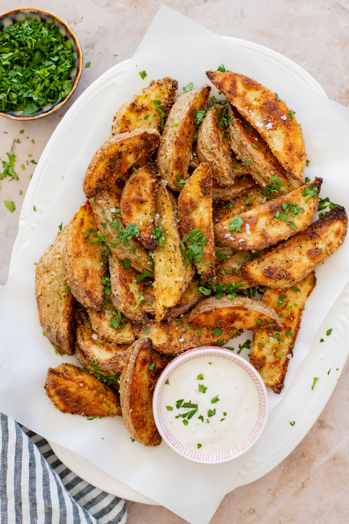 These Vegan Parmesan Crusted Potato Wedges are the most satisfying way to eat potatoes. Perfectly crispy and garlicky | ThisSavoryVegan.com