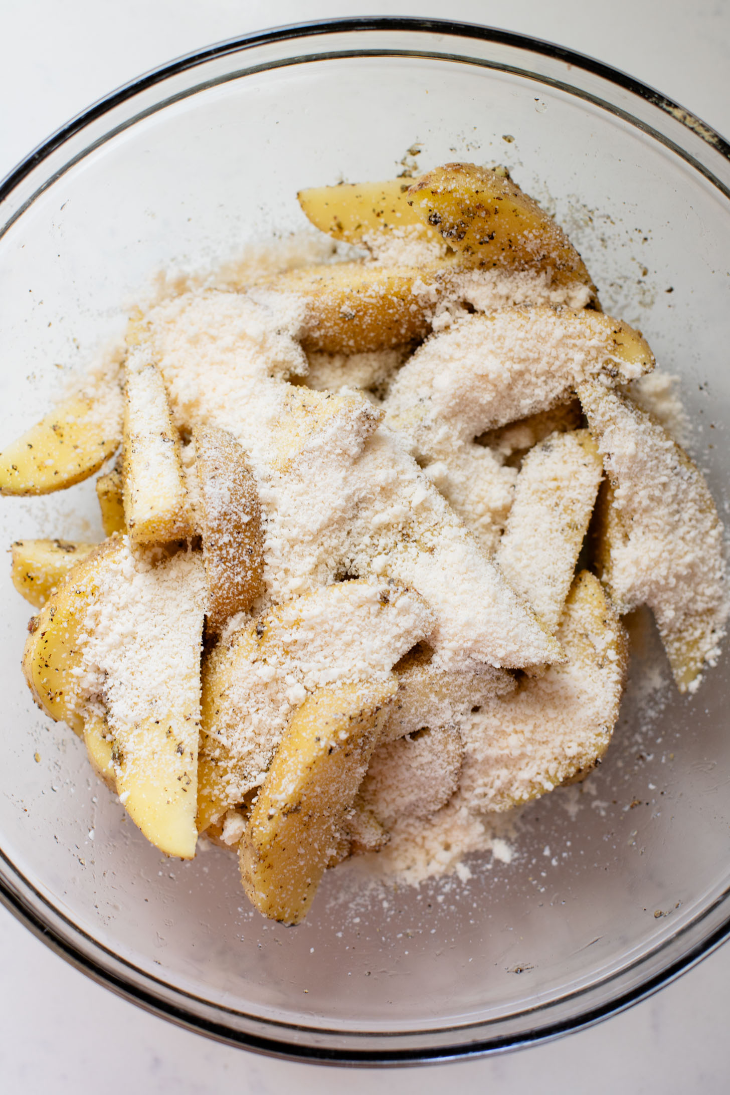 These Vegan Parmesan Crusted Potato Wedges are the most satisfying way to eat potatoes. Perfectly crispy and garlicky | ThisSavoryVegan.com