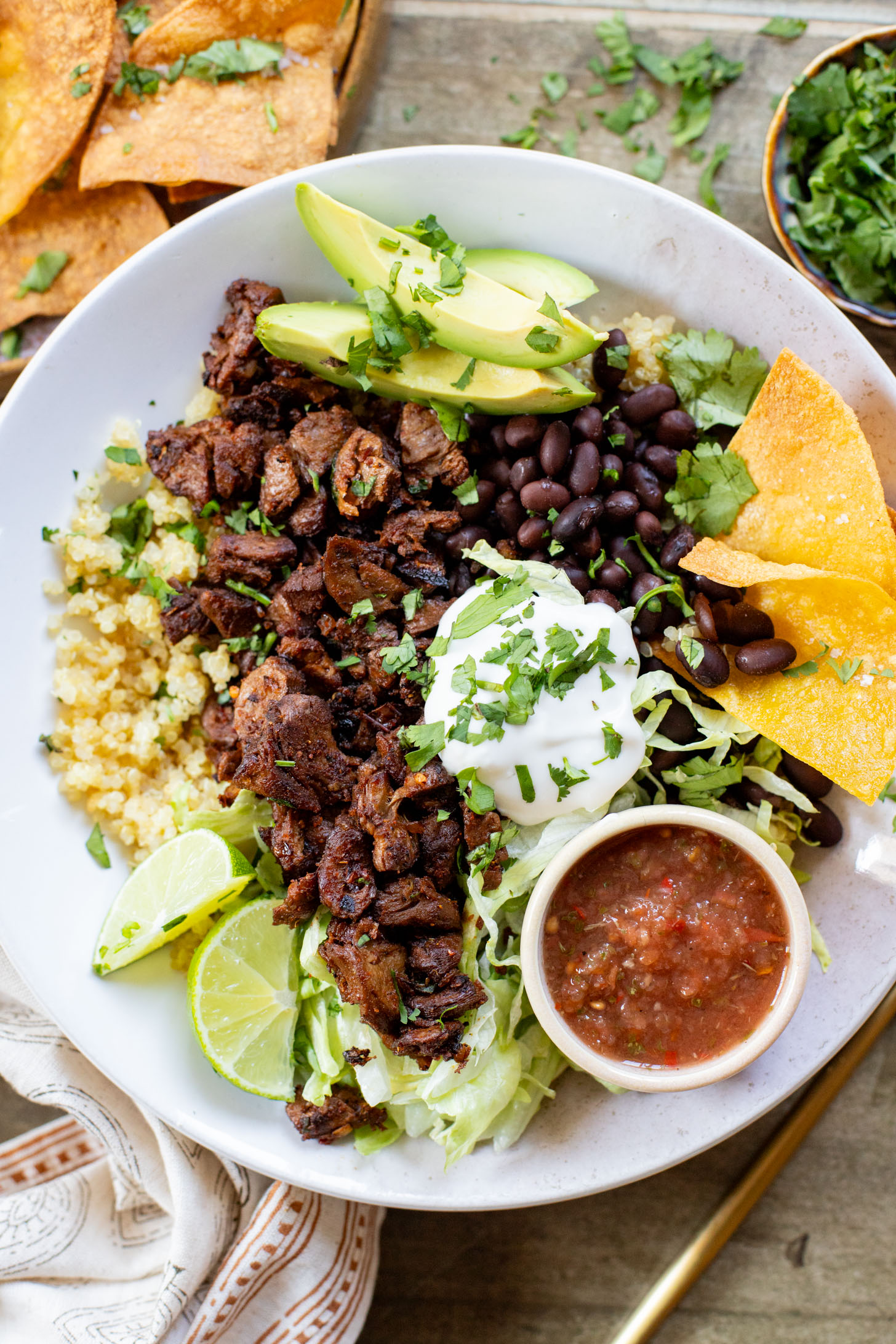 These Vegan Steak Burrito Bowls are the perfect weeknight dinner. Loaded with quinoa, vegan steak, beans and avocado - 32 grams of protein in each bowl | ThisSavoryVegan.com