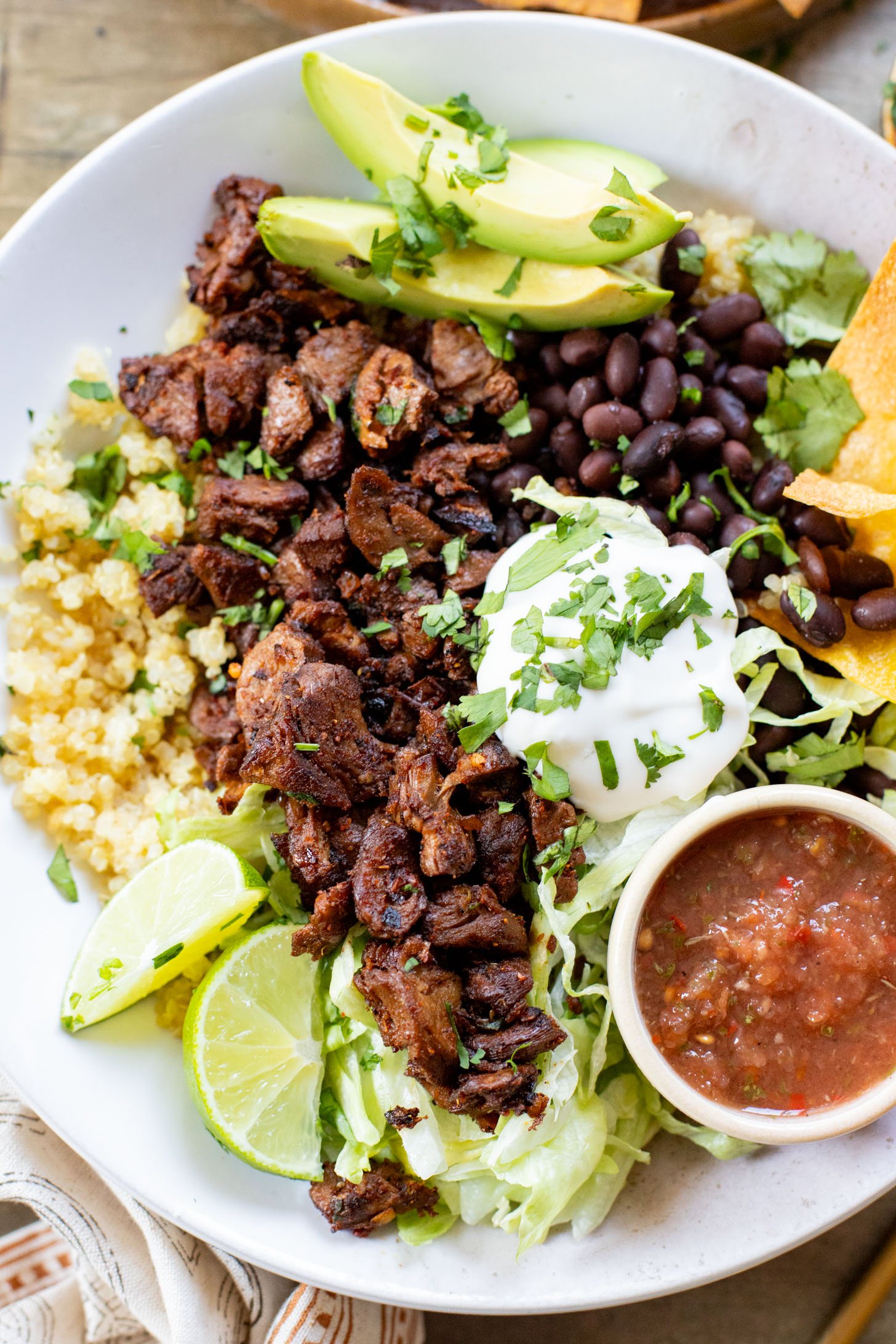These Vegan Steak Burrito Bowls are the perfect weeknight dinner. Loaded with quinoa, vegan steak, beans and avocado - 32 grams of protein in each bowl | ThisSavoryVegan.com