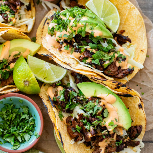 These Vegan Steak Tacos are SO good! Crispy vegan steak is cooked until super crispy and then loaded up in tortillas with a creamy chipotle sauce | ThisSavoryVegan.com