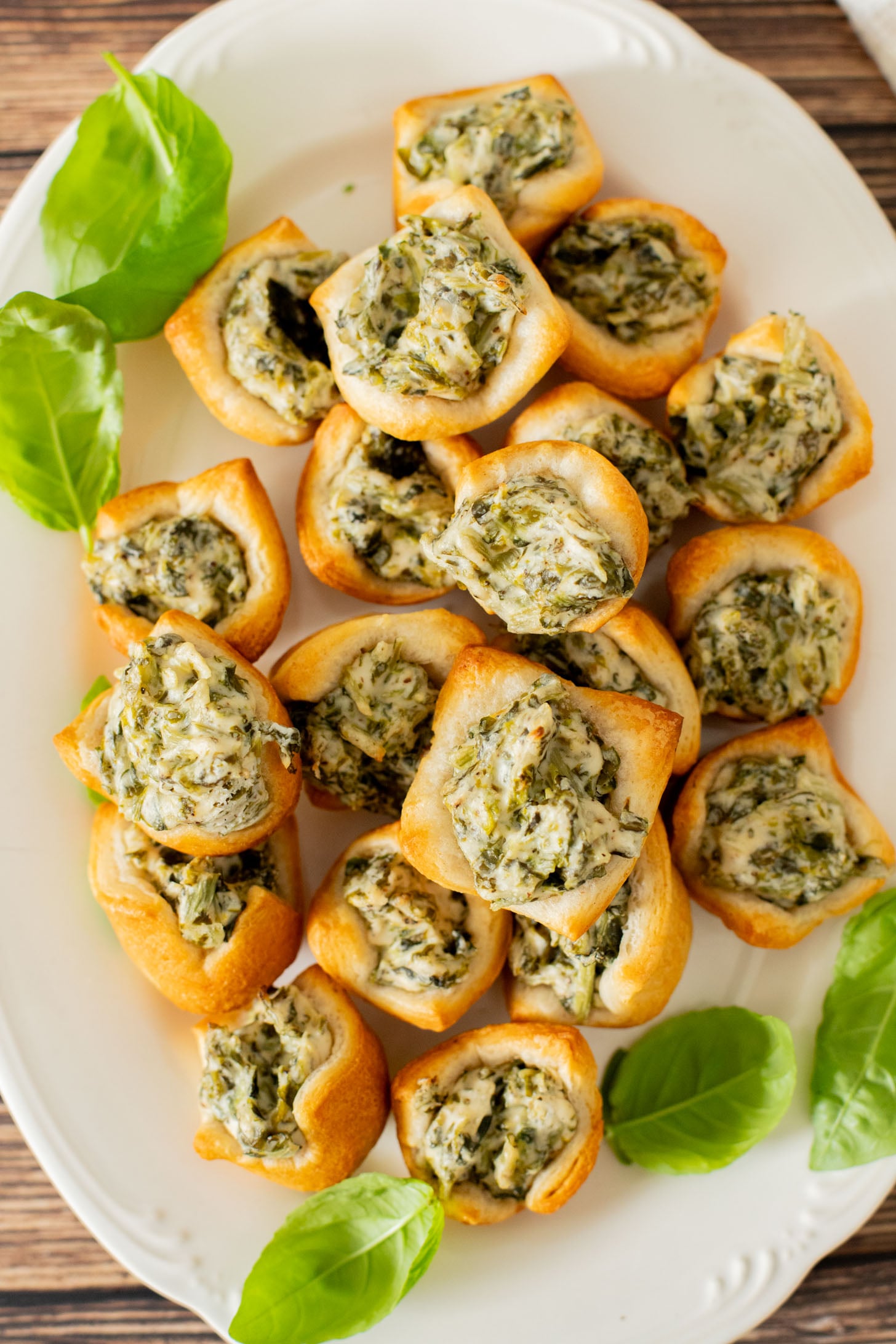 These Spinach Dip Crescent Bites are the perfect vegan holiday appetizer! Bite-sized and dairy-free, these are easy & tasty | ThisSavoryVegan.com