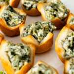 These Spinach Dip Crescent Bites are the perfect vegan holiday appetizer! Bite-sized and dairy-free, these are easy & tasty | ThisSavoryVegan.com