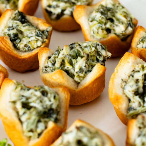 These Spinach Dip Crescent Bites are the perfect vegan holiday appetizer! Bite-sized and dairy-free, these are easy & tasty | ThisSavoryVegan.com