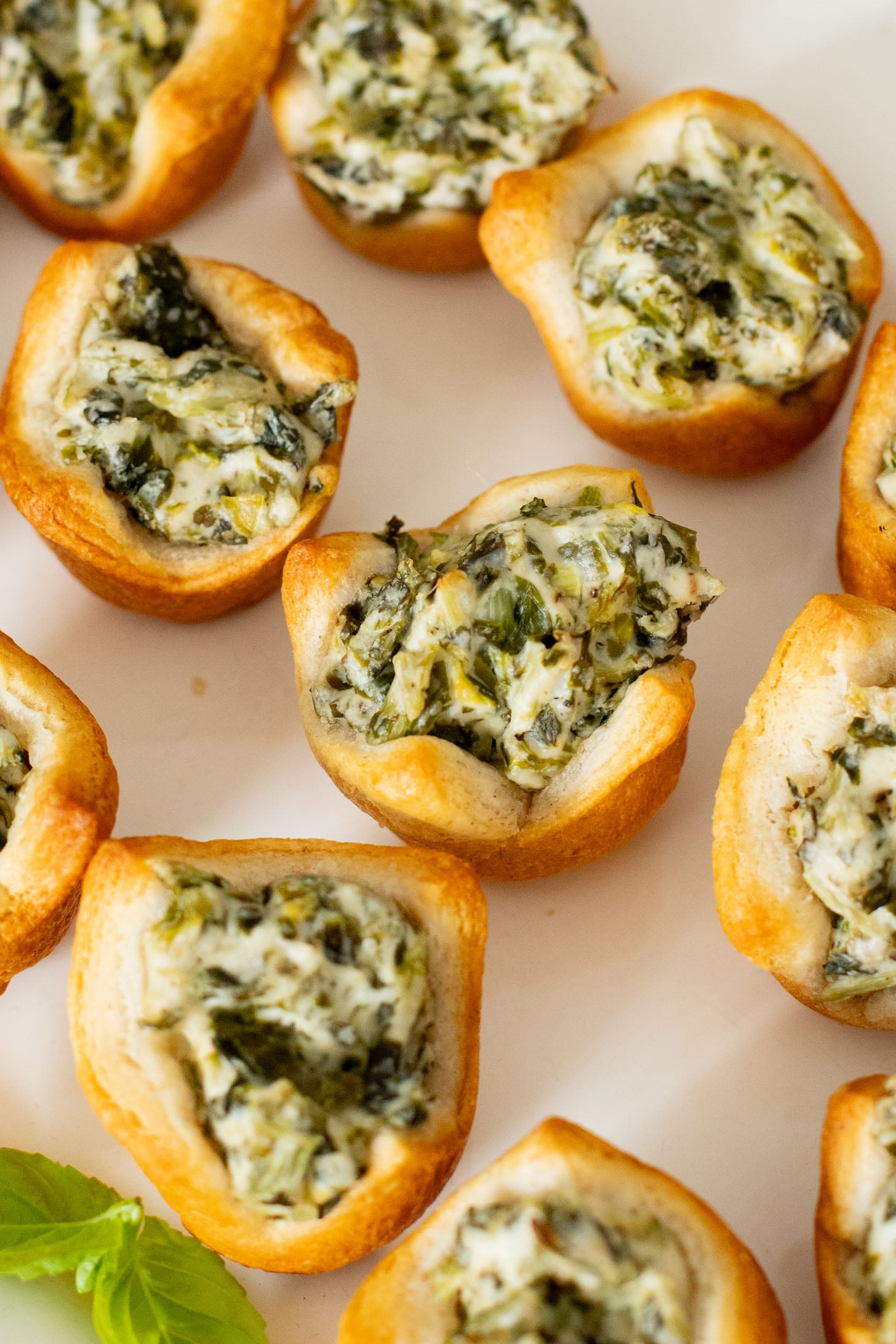 These Spinach Dip Crescent Bites are the perfect vegan holiday appetizer! Bite-sized and dairy-free, these are easy & tasty | ThisSavoryVegan.com