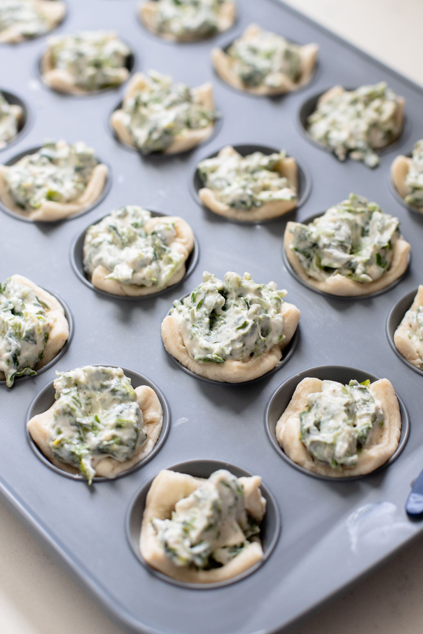 These Spinach Dip Crescent Bites are the perfect vegan holiday appetizer! Bite-sized and dairy-free, these are easy & tasty | ThisSavoryVegan.com