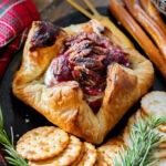This Vegan Cranberry Baked Brie is a holiday must make! Vegan brie is topped with cranberry sauce & baked in puff pastry for the best vegan appetizer | ThisSavoryVegan.com