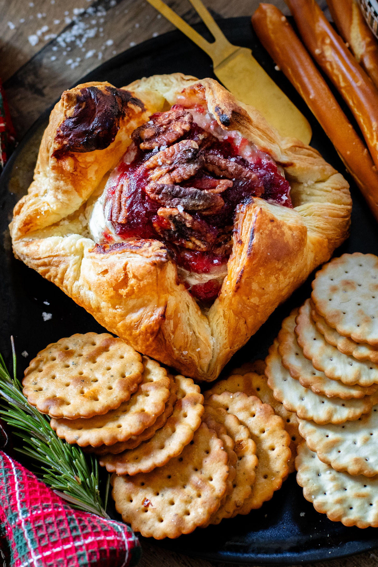 This Vegan Cranberry Baked Brie is a holiday must make! Vegan brie is topped with cranberry sauce & baked in puff pastry for the best vegan appetizer | ThisSavoryVegan.com