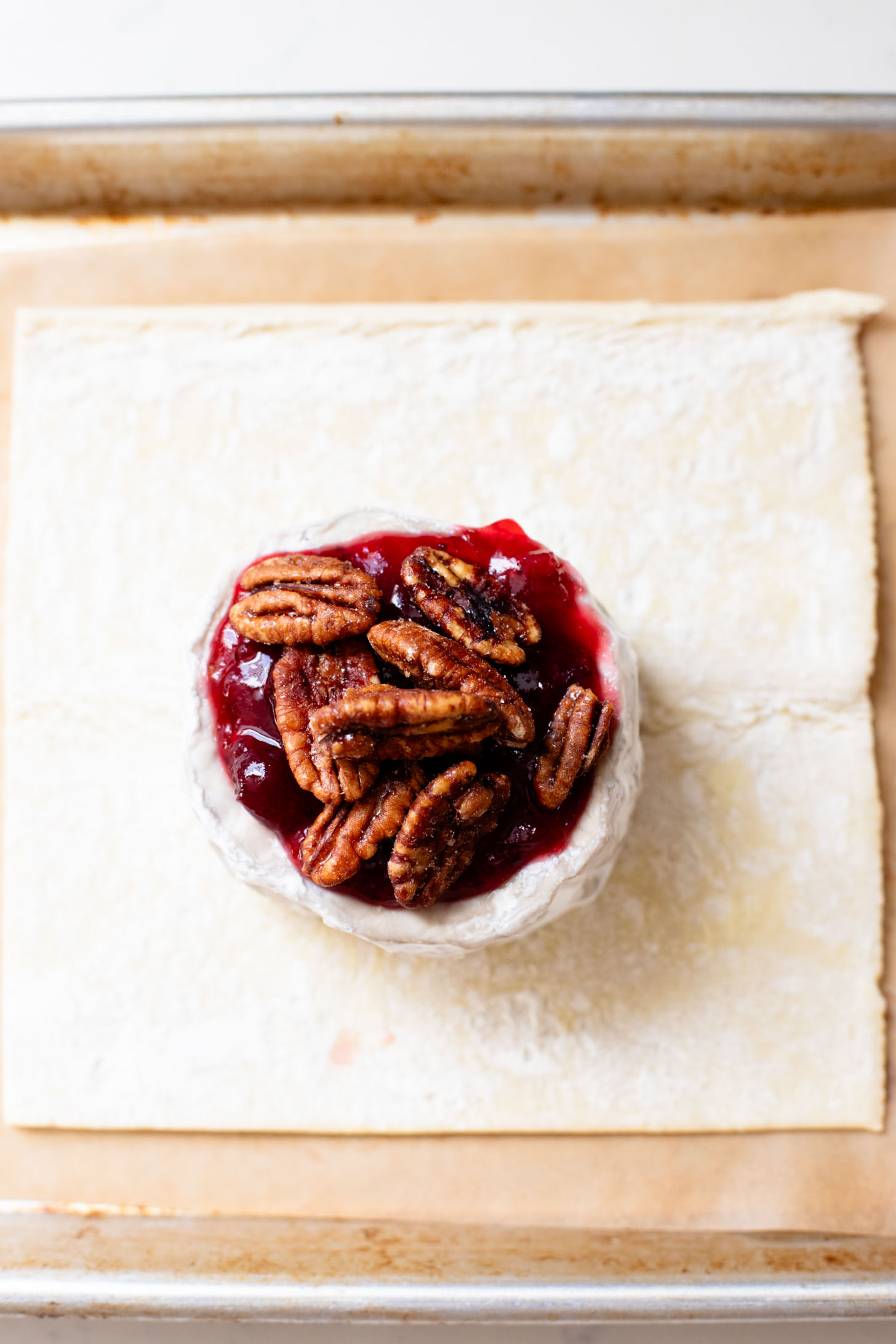 This Vegan Cranberry Baked Brie is a holiday must make! Vegan brie is topped with cranberry sauce & baked in puff pastry for the best vegan appetizer | ThisSavoryVegan.com