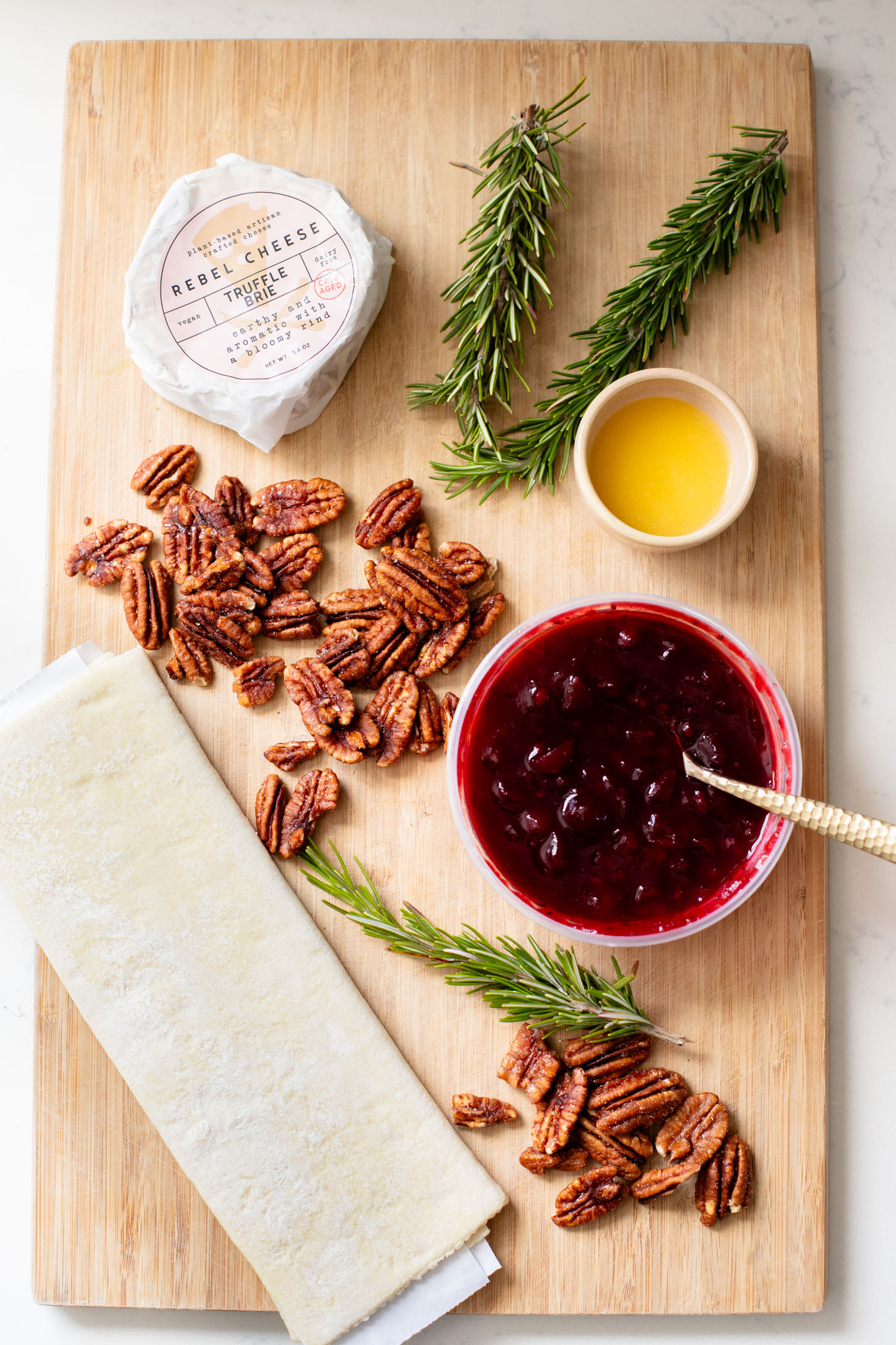 This Vegan Cranberry Baked Brie is a holiday must make! Vegan brie is topped with cranberry sauce & baked in puff pastry for the best vegan appetizer | ThisSavoryVegan.com
