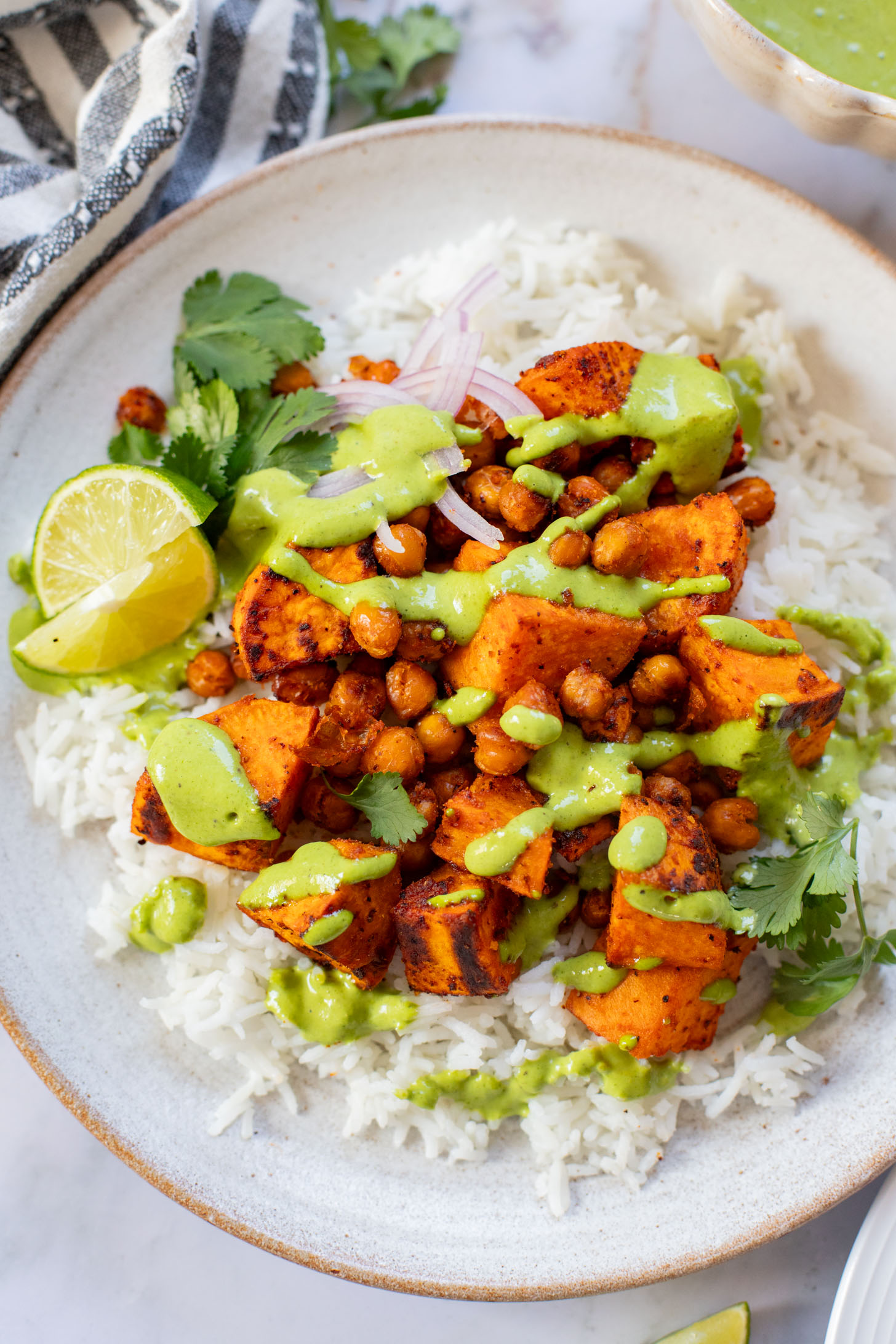 These Chipotle Sweet Potatoes & Chickpeas are made on one sheet pan and served over rice with the BEST cilantro dressing | ThisSavoryVegan.com
