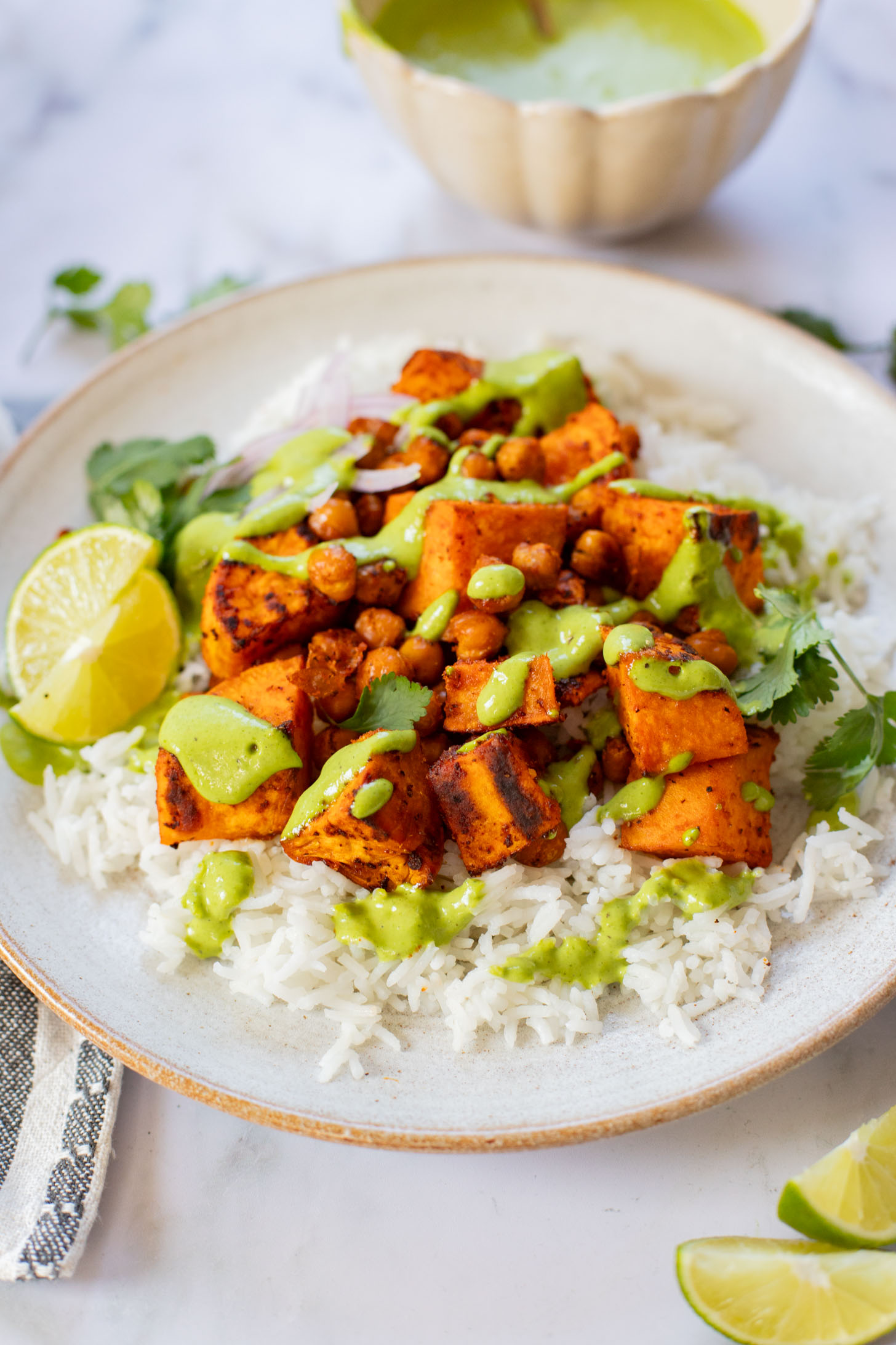 These Chipotle Sweet Potatoes & Chickpeas are made on one sheet pan and served over rice with the BEST cilantro dressing | ThisSavoryVegan.com