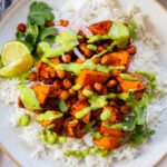 These Chipotle Sweet Potatoes & Chickpeas are made on one sheet pan and served over rice with the BEST cilantro dressing | ThisSavoryVegan.com