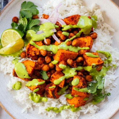 These Chipotle Sweet Potatoes & Chickpeas are made on one sheet pan and served over rice with the BEST cilantro dressing | ThisSavoryVegan.com