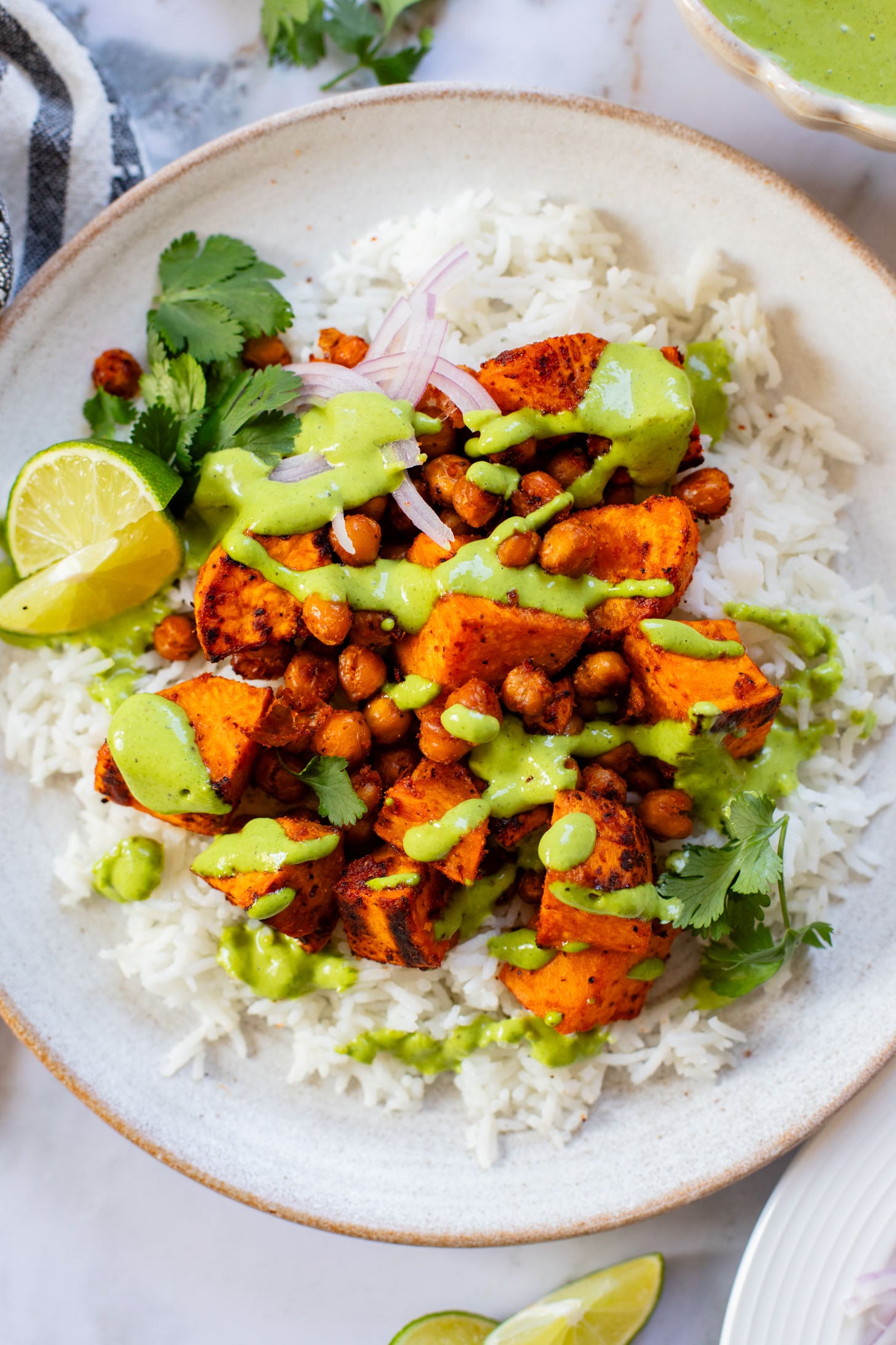 These Chipotle Sweet Potatoes & Chickpeas are made on one sheet pan and served over rice with the BEST cilantro dressing | ThisSavoryVegan.com