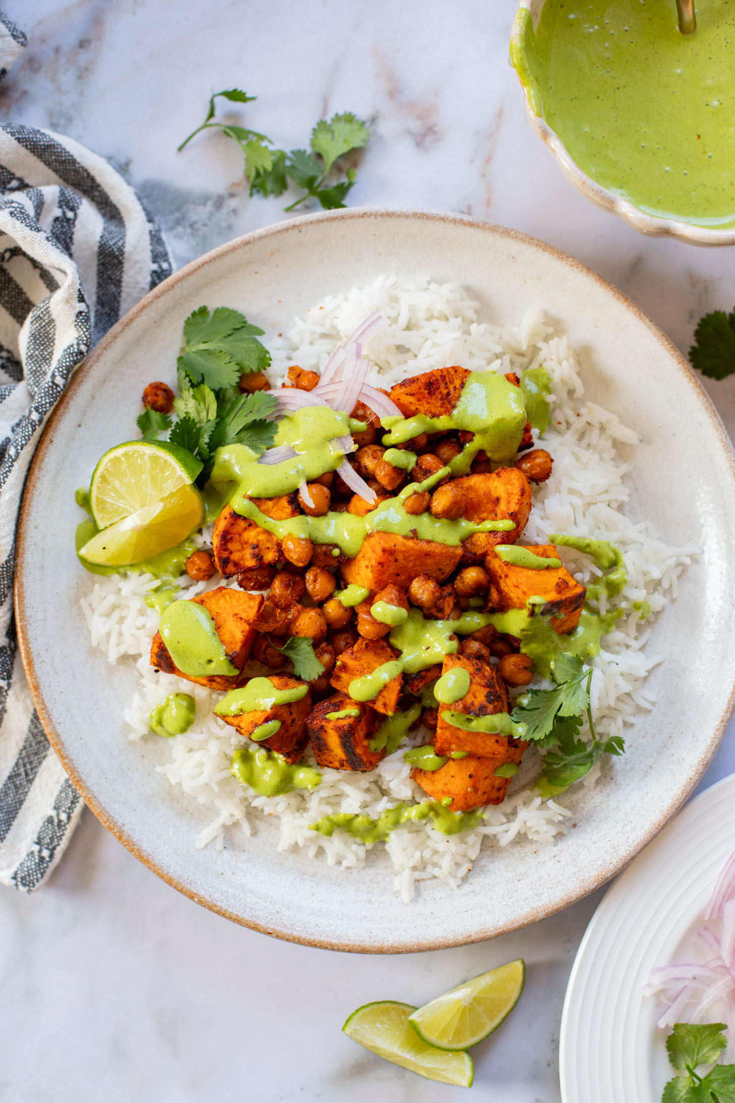These Chipotle Sweet Potatoes & Chickpeas are made on one sheet pan and served over rice with the BEST cilantro dressing | ThisSavoryVegan.com