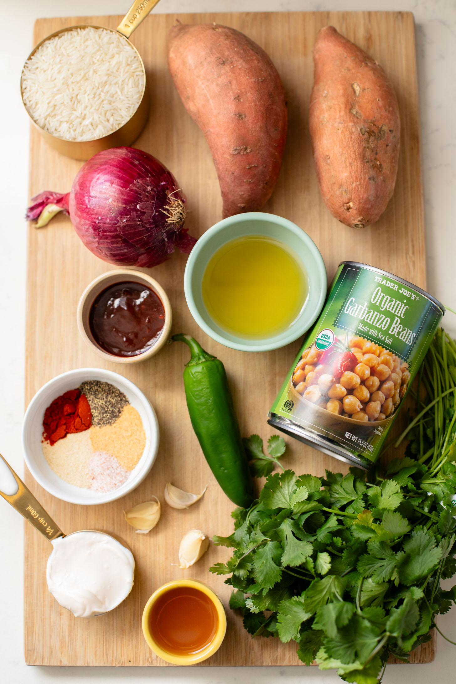 These Chipotle Sweet Potatoes & Chickpeas are made on one sheet pan and served over rice with the BEST cilantro dressing | ThisSavoryVegan.com