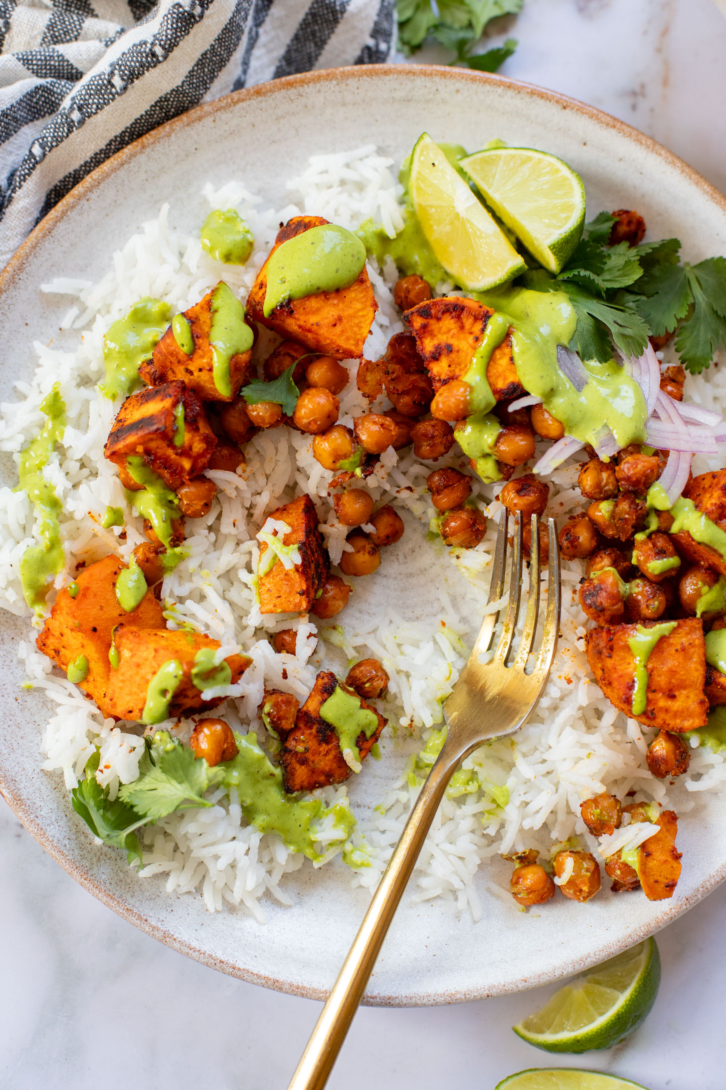 These Chipotle Sweet Potatoes & Chickpeas are made on one sheet pan and served over rice with the BEST cilantro dressing | ThisSavoryVegan.com