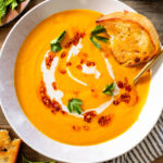 This Creamy Roasted Carrot Soup is dairy-free and packed with veggies. A super simple vegan soup recipe that packs lots of flavor | ThisSavoryVegan.com